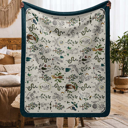 This image shows the size. It's a person holding up the Fierce, Feral, and Free sherpa blanket in a cozy boho-style apartment.