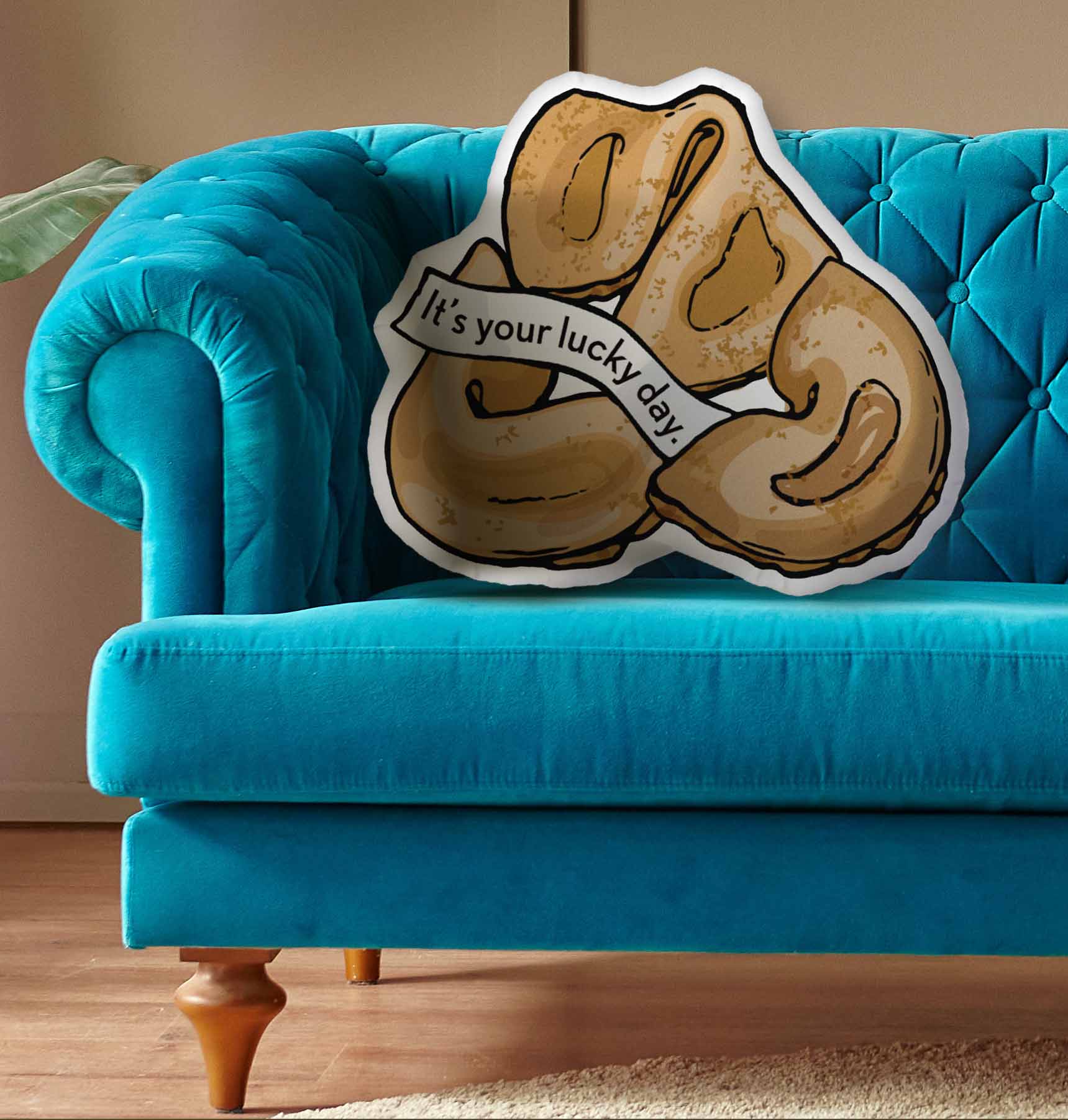 This photo shows the pillow on a bright blue couch.
