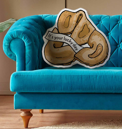 This photo shows the pillow on a bright blue couch.