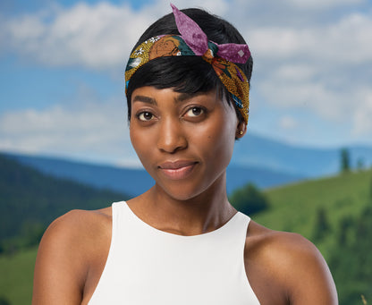 This is an image of a woman wearing the fox and flower around her head in a headscarf boho style. There is a mountain range in the background.
