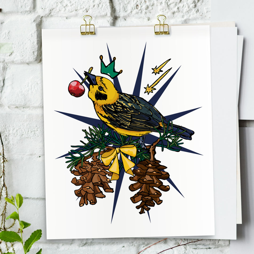 Gold Finch art print hanging from a white bring wall with gold clips.