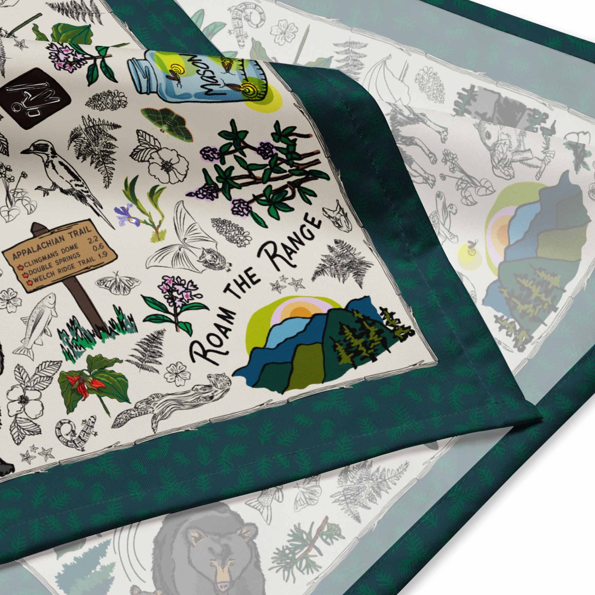 This is a close-up image of the bandana scarf to show the texture and illustration style. It shows the corner with the mountain sunset.