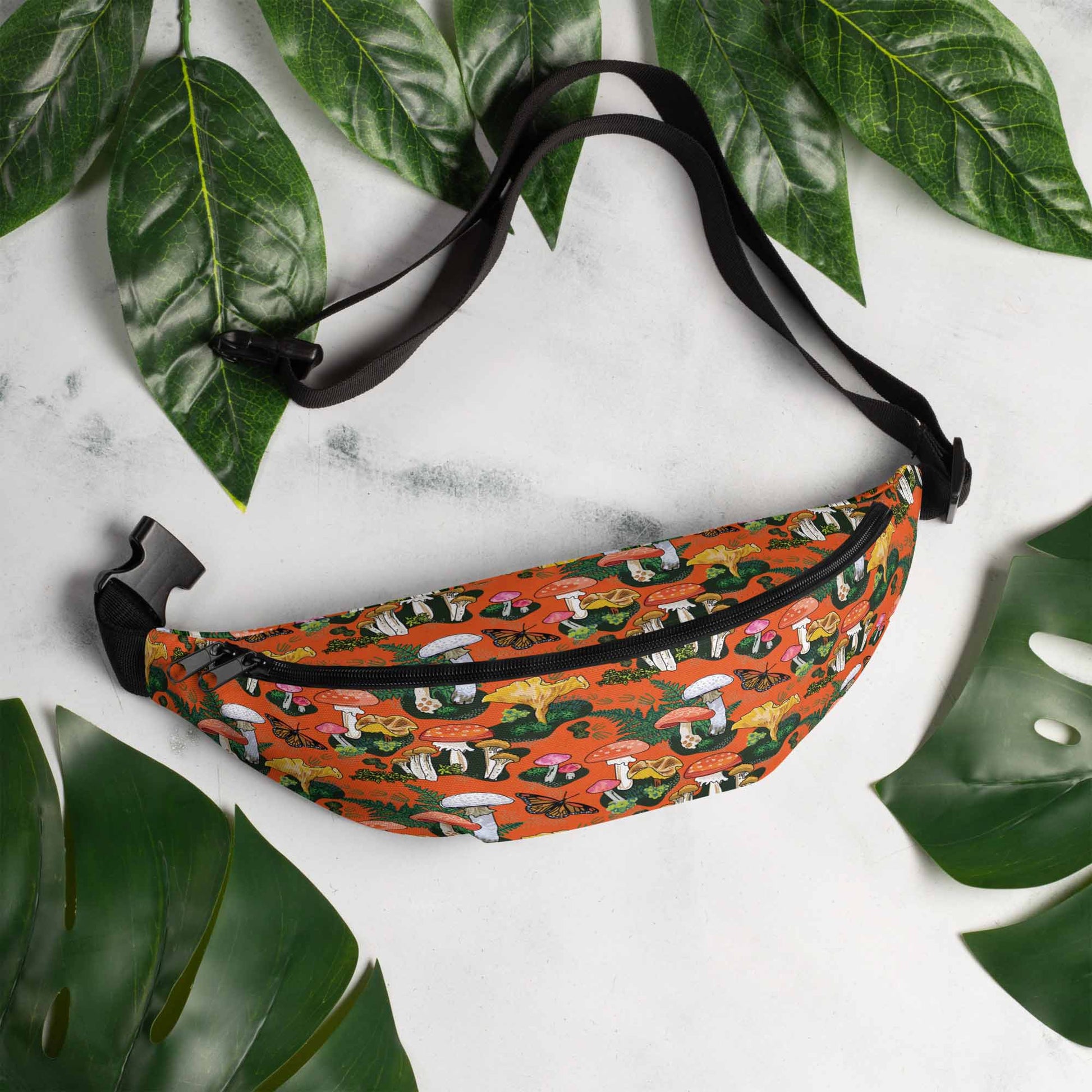 Red Mushrooms Hip Pack on marble surrounded by leaves | Hiking Sling Bag | Festival Gear
