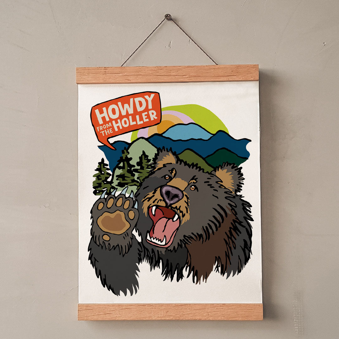 Poster with a bear illustration and 'Howdy from the Holler' text on a beige wall.