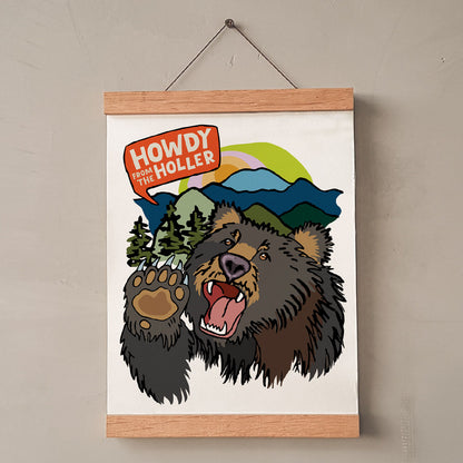 Poster with a bear illustration and 'Howdy from the Holler' text on a beige wall.
