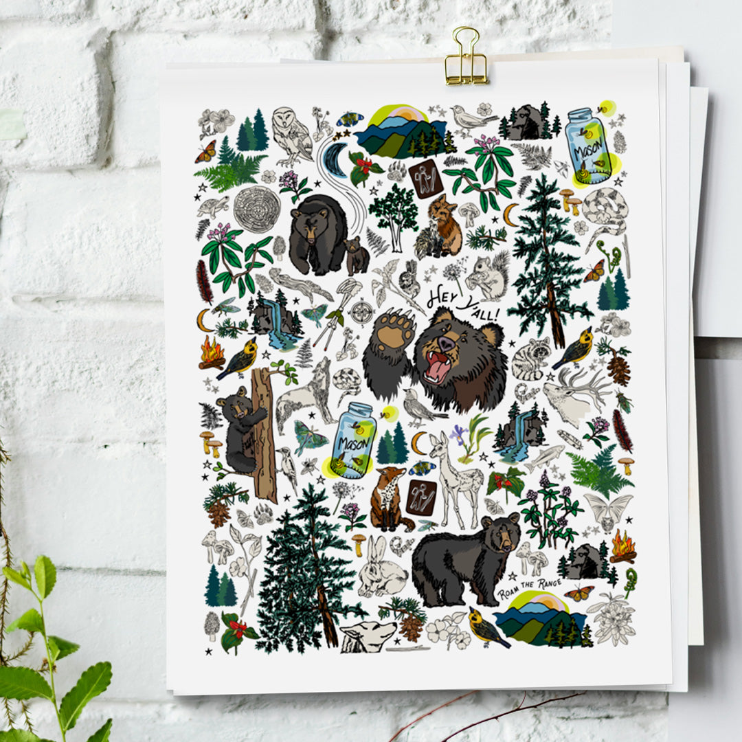 Mountain Hikes art print hanging from a white bring wall with gold clips.
