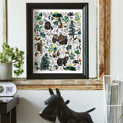 The Mountain Hikes art pPrint poster framed in a heavy black frame and hung inside a vintage frame above a desk.