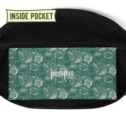 View of the inside pocket. It has a white pattern of bear paws, mushrooms, butterflies, and leaves on a green background. The Posh Pad logo is in the middle.
