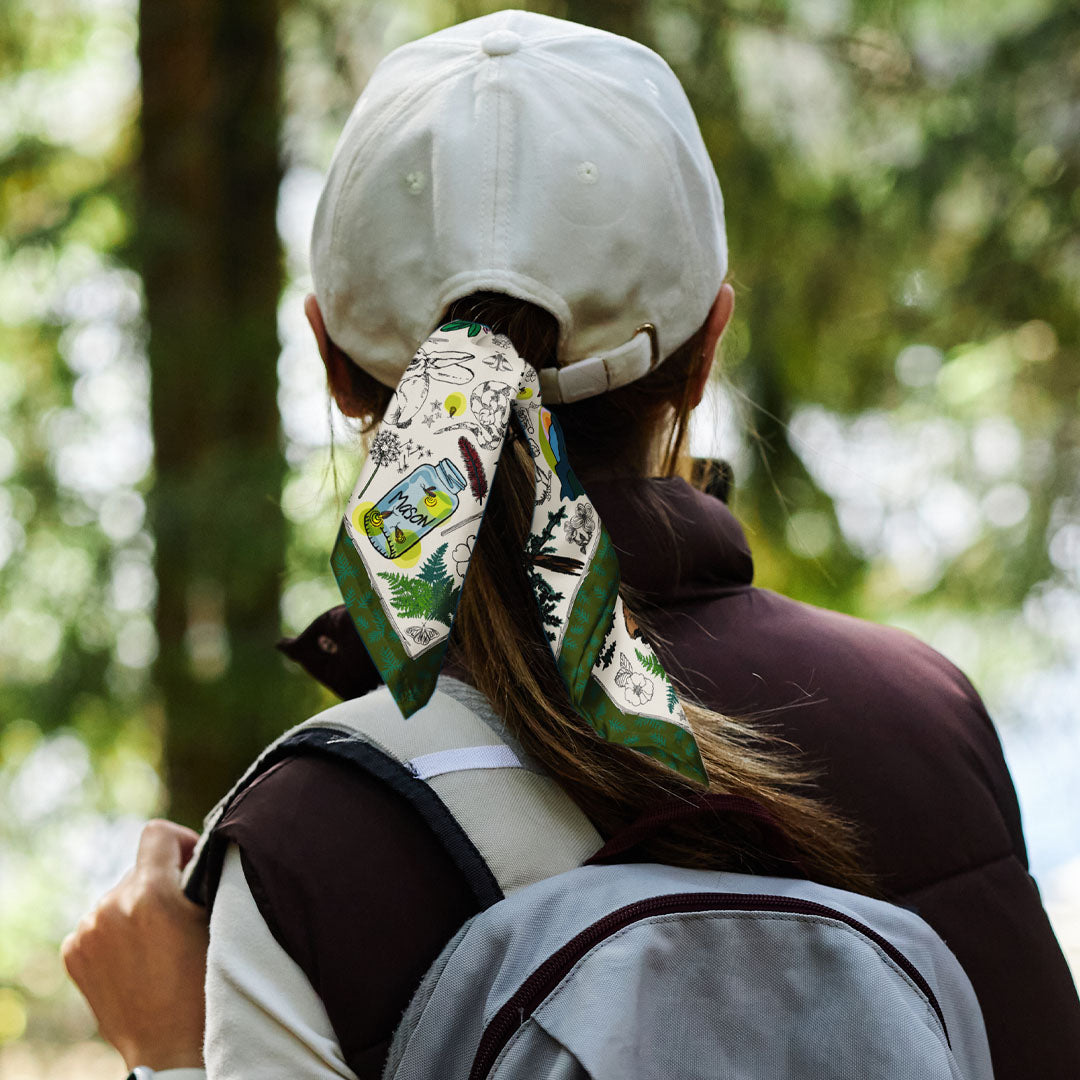 Woman wearing the Mountain Hikes Bandana scarf as a ponytail tie.