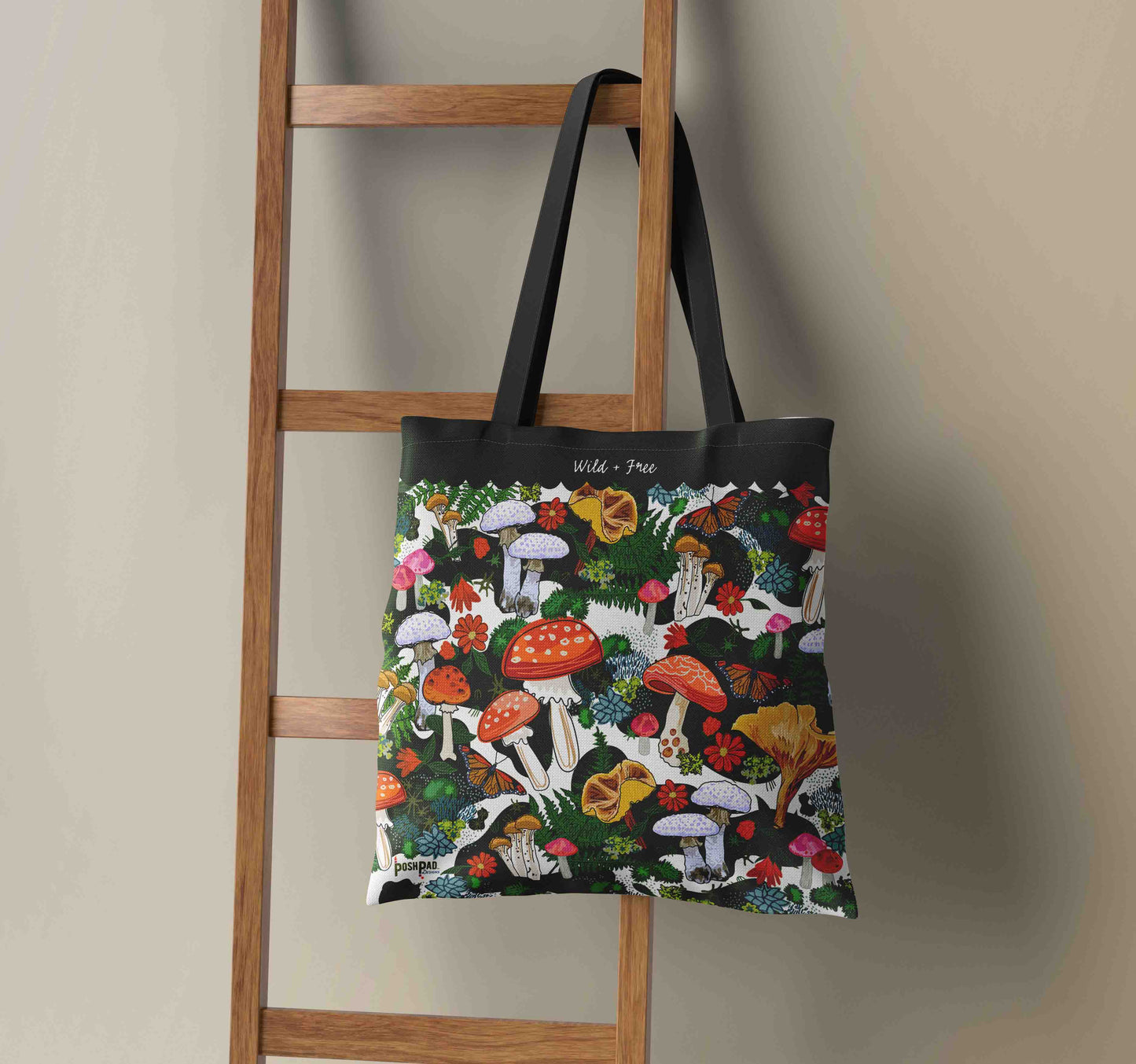 Red Mushroom Tote hanging on a wooden ladder. 