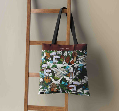 This image shows the Green Mushroom weekender tote hanging on a wooden ladder.