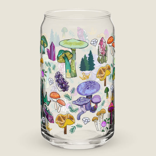 Image of the mushroom and crystal glass tumbler on an ivory background. The artwork has illustrations of a variety of mushrooms in every color, a collection of crystals, crowns, and tiny pine trees.