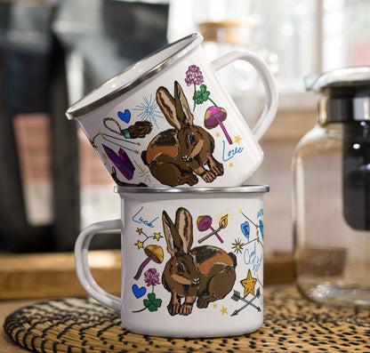 This is a photo of the Orion Stars enamel coffee mugs stacked on a kitchen counter sitting beside a coffee pot and bags of coffee.
