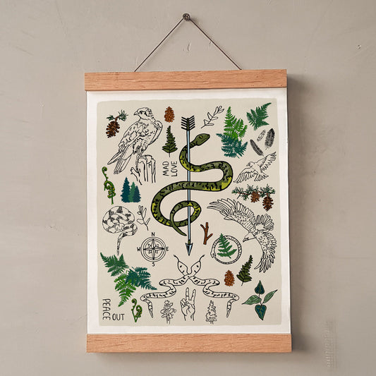 Peace Out in the Woods art print poster hung in a wood wall hanger. The artwork has illustrations of eagles, snakes, ferns, north star compass, pinecones, pine trees, an arrow, feathers, peace sign, and forest icons. 