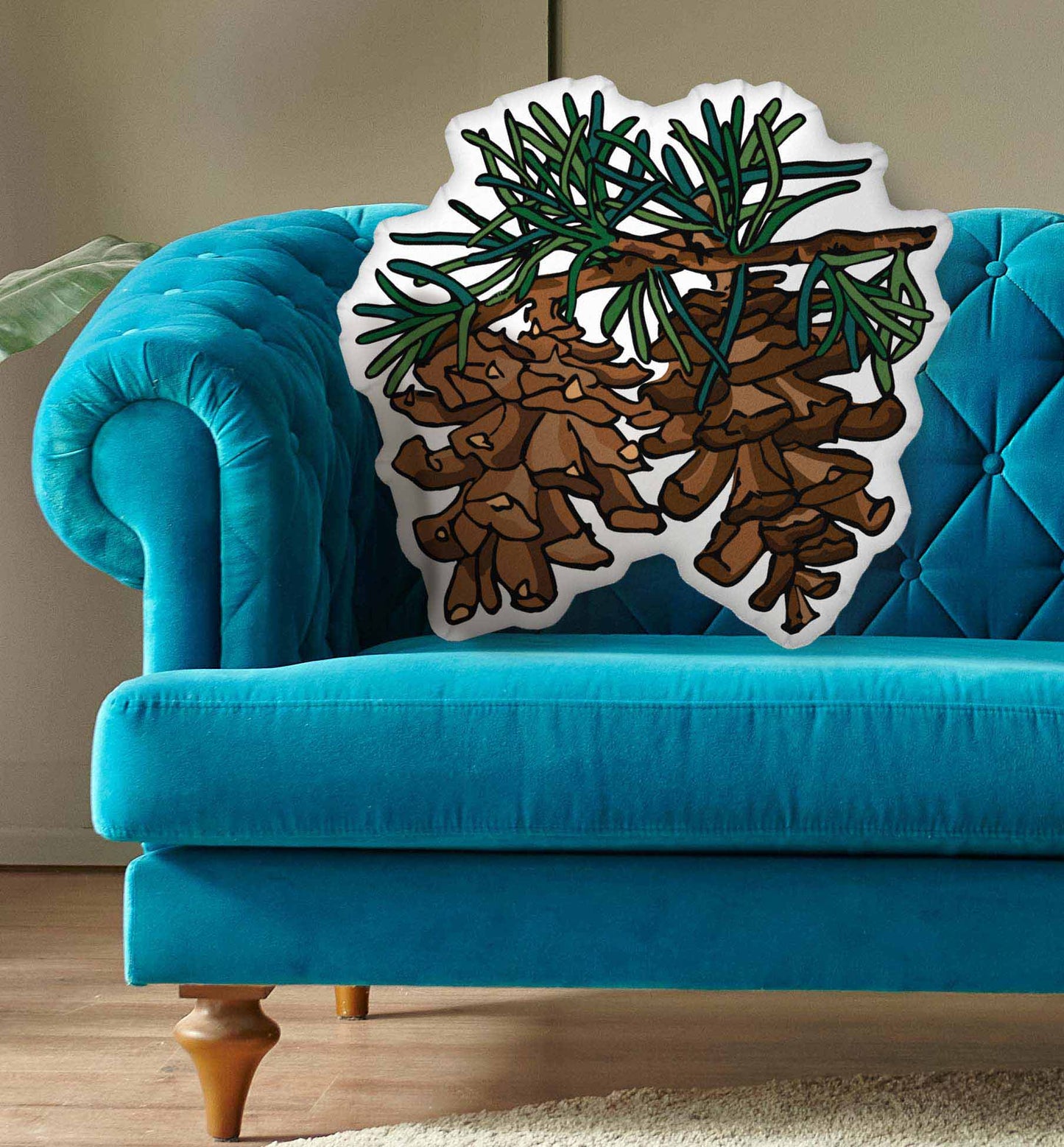 Pinecone pillow on a blue background.