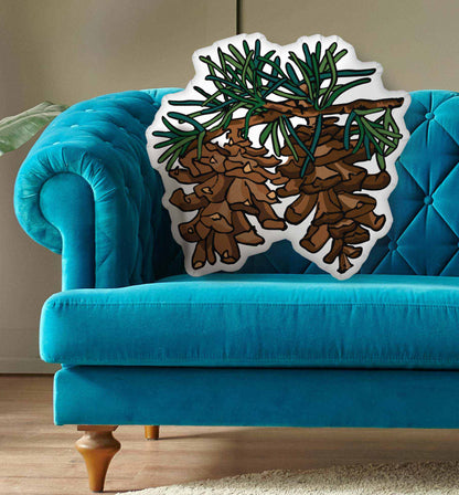 Pinecone pillow on a blue background.