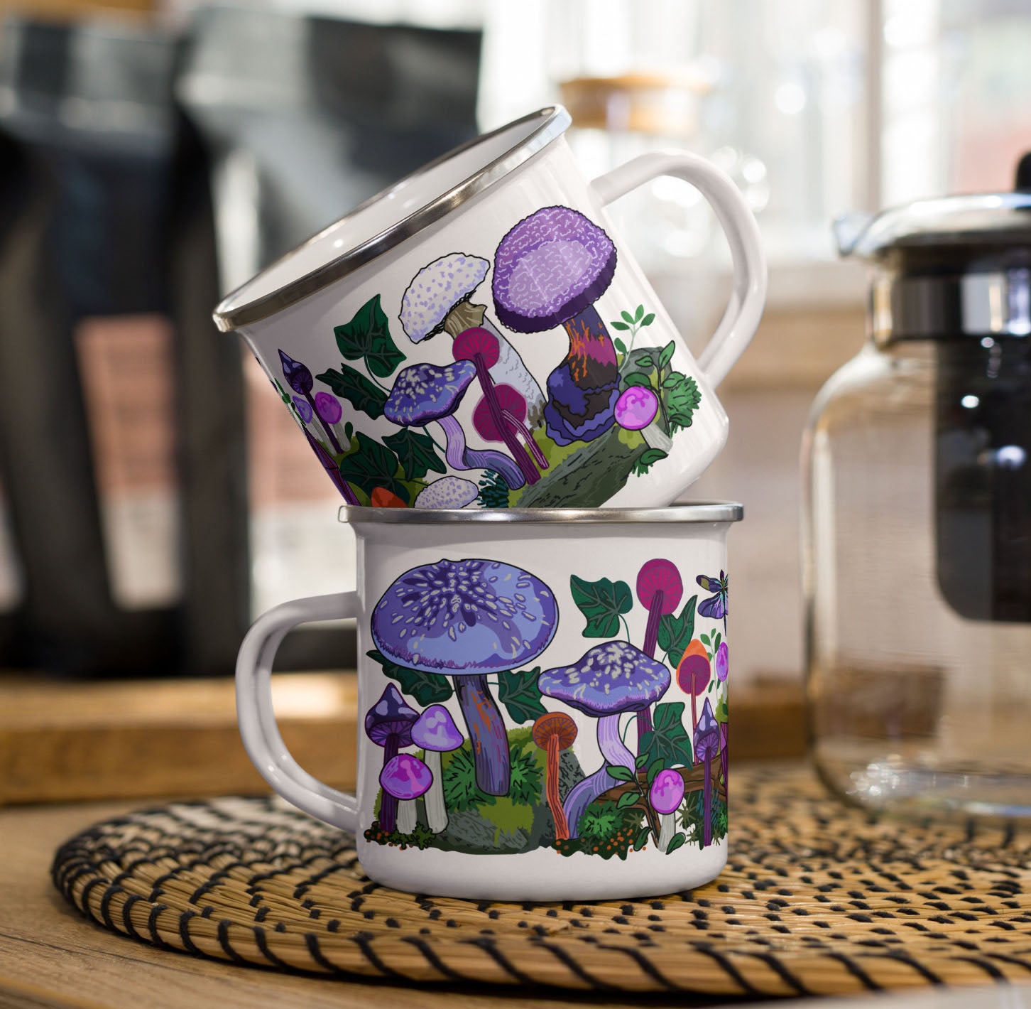 Two purple enamel coffee cups stacked on a kitchen counter.