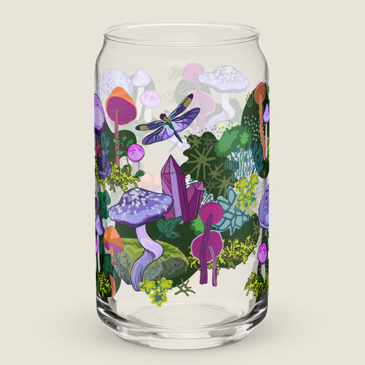 Purple Mushrooms glass tumbler on an ivory background. The artwork on the glass is a collection of purple and orange mushrooms, dragonflies, and various mosses nestled among wild ivy. The primary color palette is purples, vibrant oranges, and forest greens.