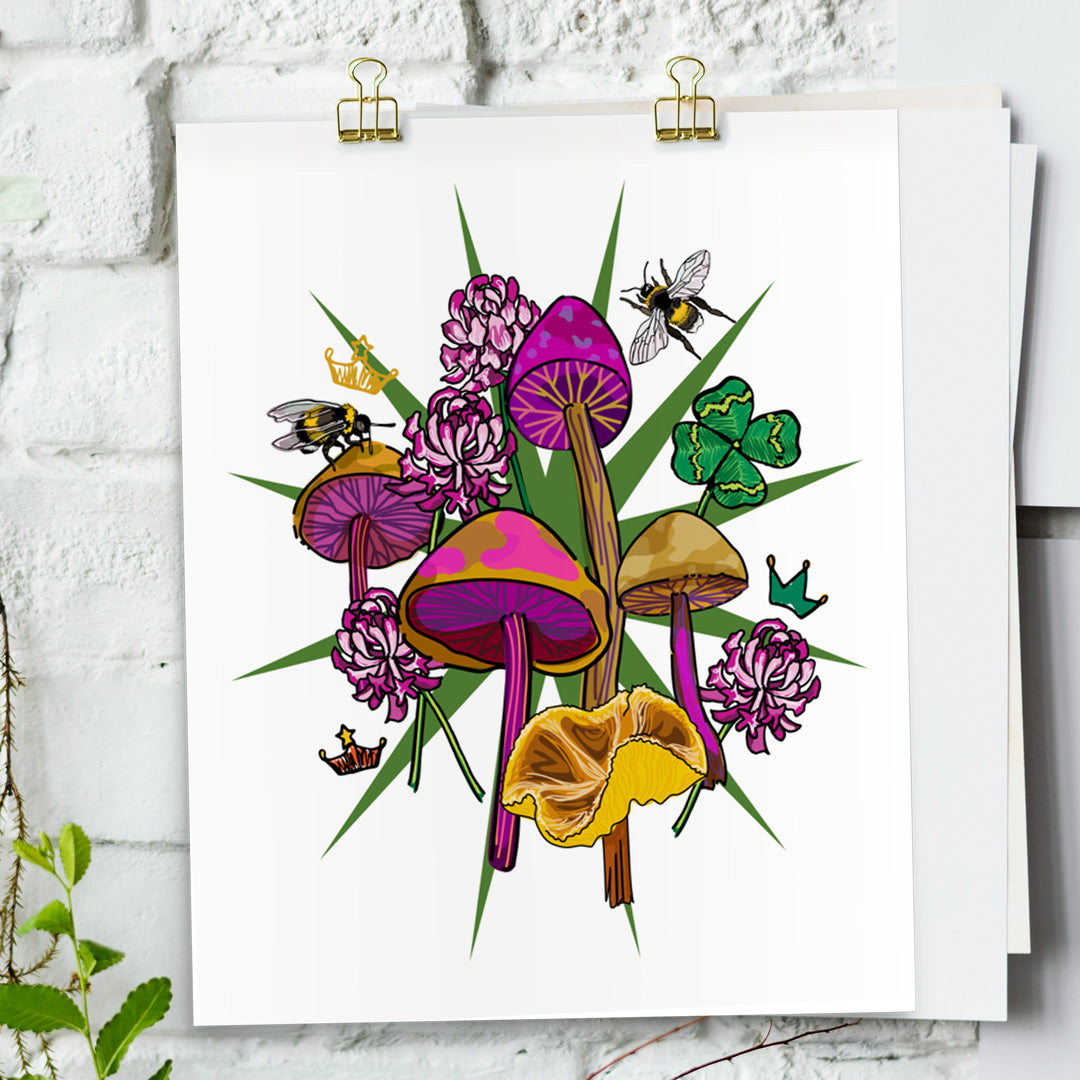Queen Bee & Mushrooms art print hanging from a white bring wall with gold clips.