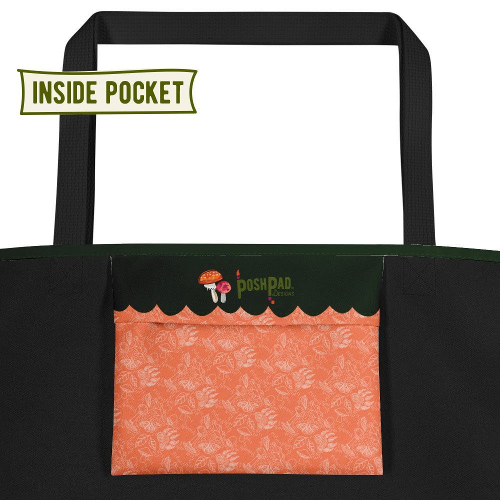 This is an image of the inside pocket. There is a tiny mushroom illustration. The bottom of the pocket has pattern with bear paw prints, mushrooms, butterflies and flowers.