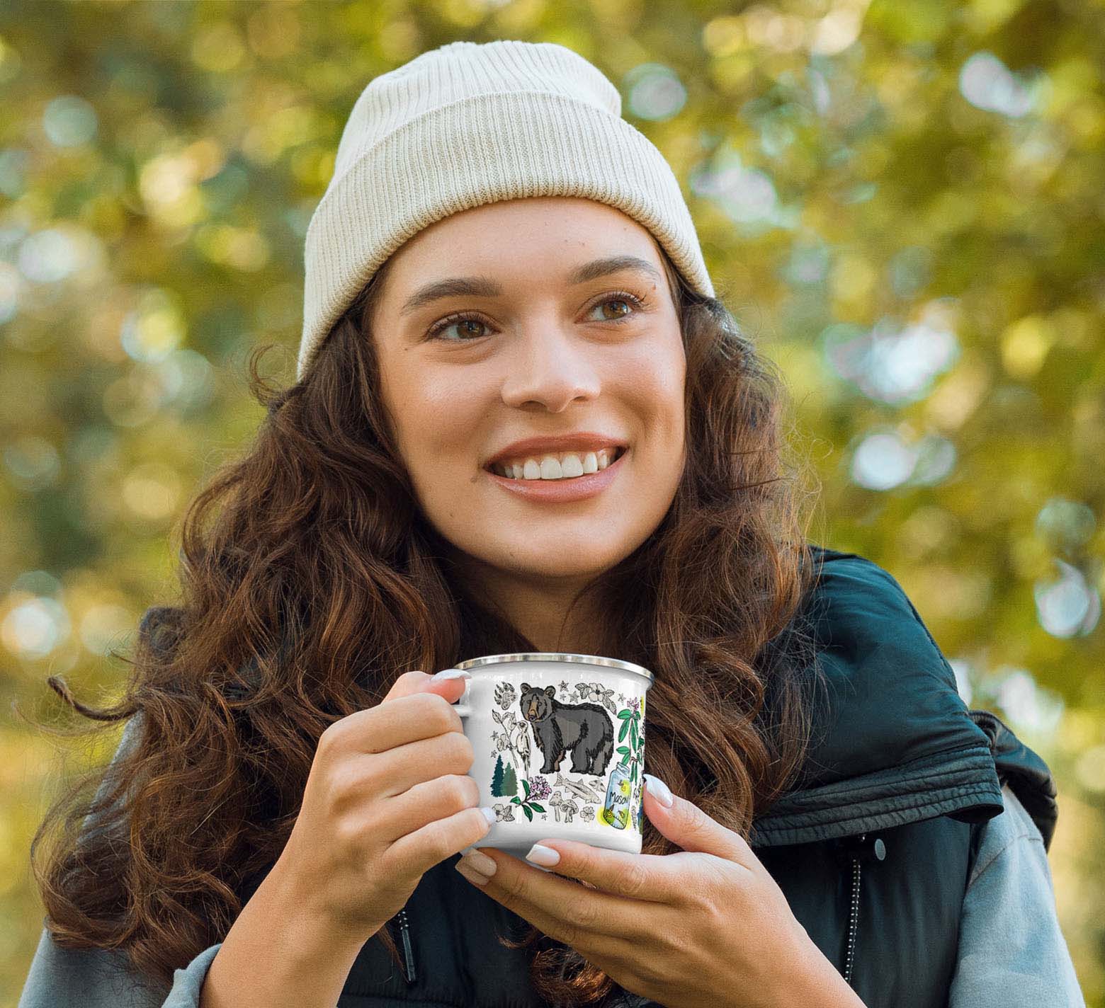 Image of a female hiker holding the mug.
