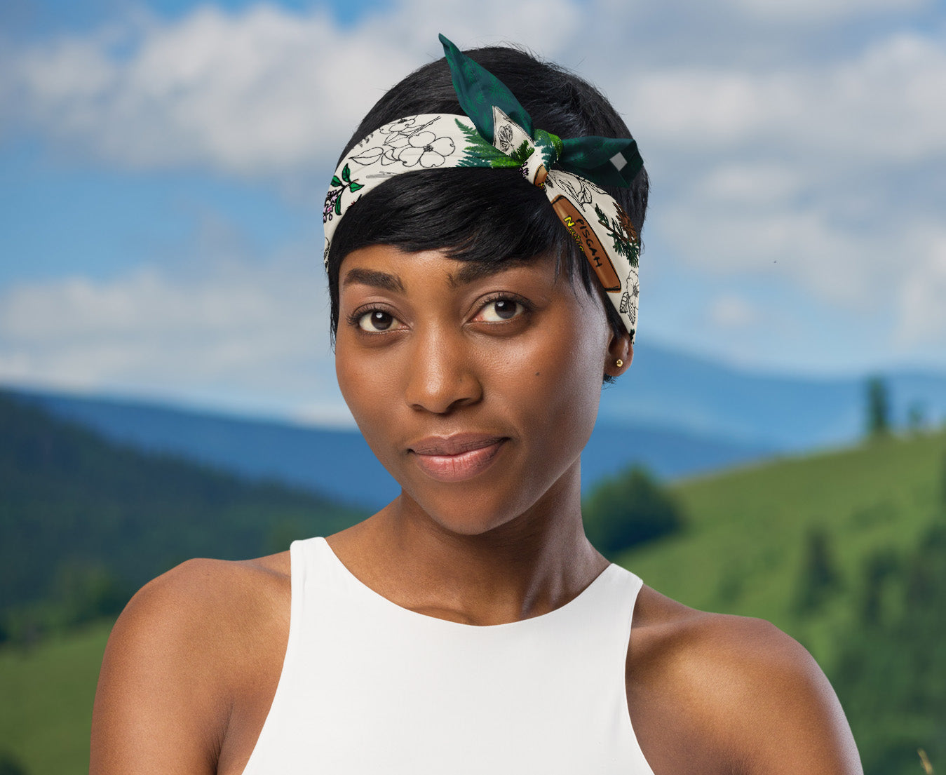 Woman wearing the smokies Mountains bandana as a head wrap.  There are mountains in the background.