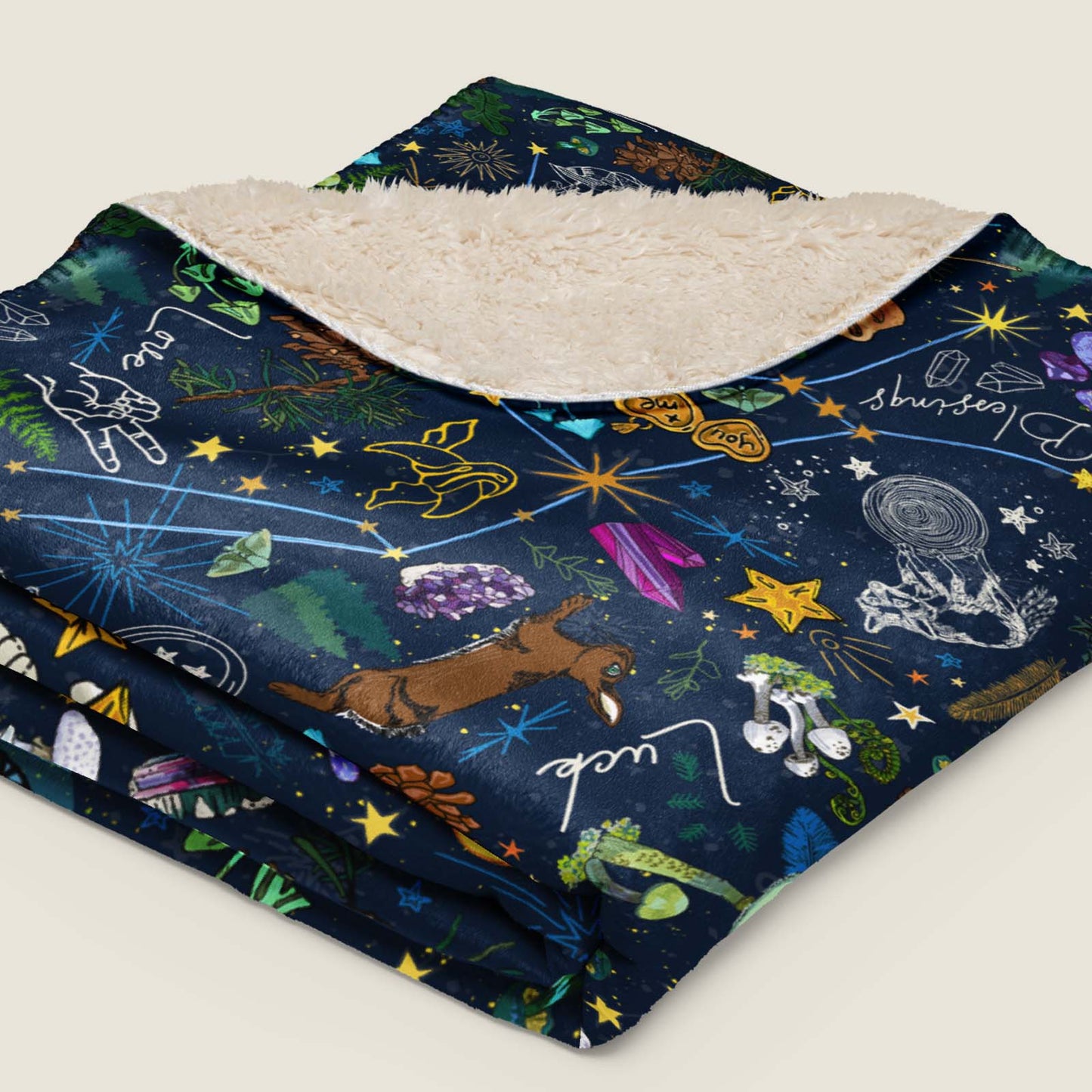 Under the Stars Faux Fur Sherpa blanket folded and lying on an ivory background.
