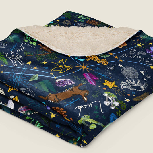 Under the Stars Faux Fur Sherpa blanket folded and lying on an ivory background.
