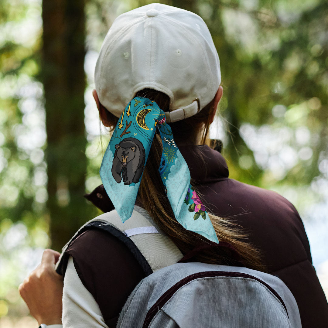 Ursa Major & Minor Stars Bandana tied to a baseball cap being worn by a female hiker.