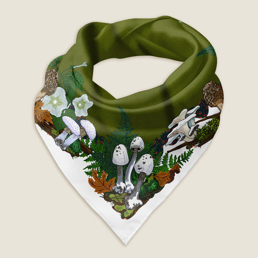The white mushroom bandana styled as a wrap shows the details of the hand-drawn artwork, which includes a variety of white and brown mushrooms, moths, ferns, white morning glory flowers, and moss illustrated around a green middle with a white border. The green mushroom bandana scarf is set on an ivory background.