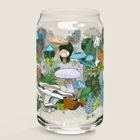 The White Mushroom glass tumbler on an ivory background. The artwork on the glass is illustrations of various white, blue, and brown mushrooms, leaves, and moss, alongside blue and red butterflies. The color palette is primarily white, blues, browns, and mossy greens with accents of red.