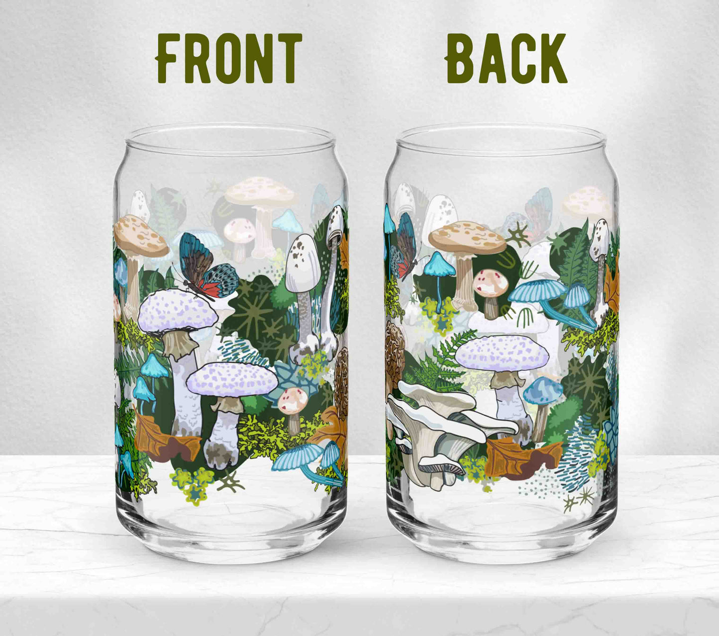 Two glasses sitting on marble. Each one is turned in a different direction to show the front and the back of the design, which includes various white, blue, and brown mushrooms, leaves, and moss, alongside blue and red butterflies. 