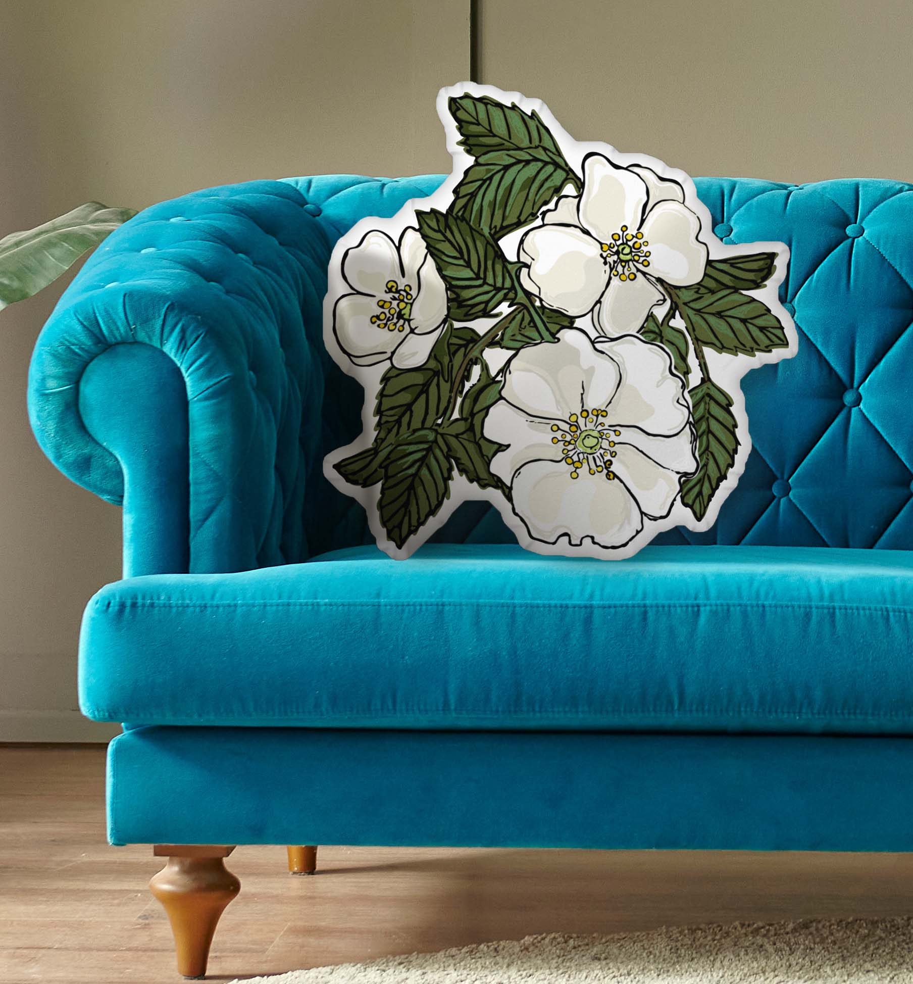 This is a photo of the shaped pillow on a blue couch.