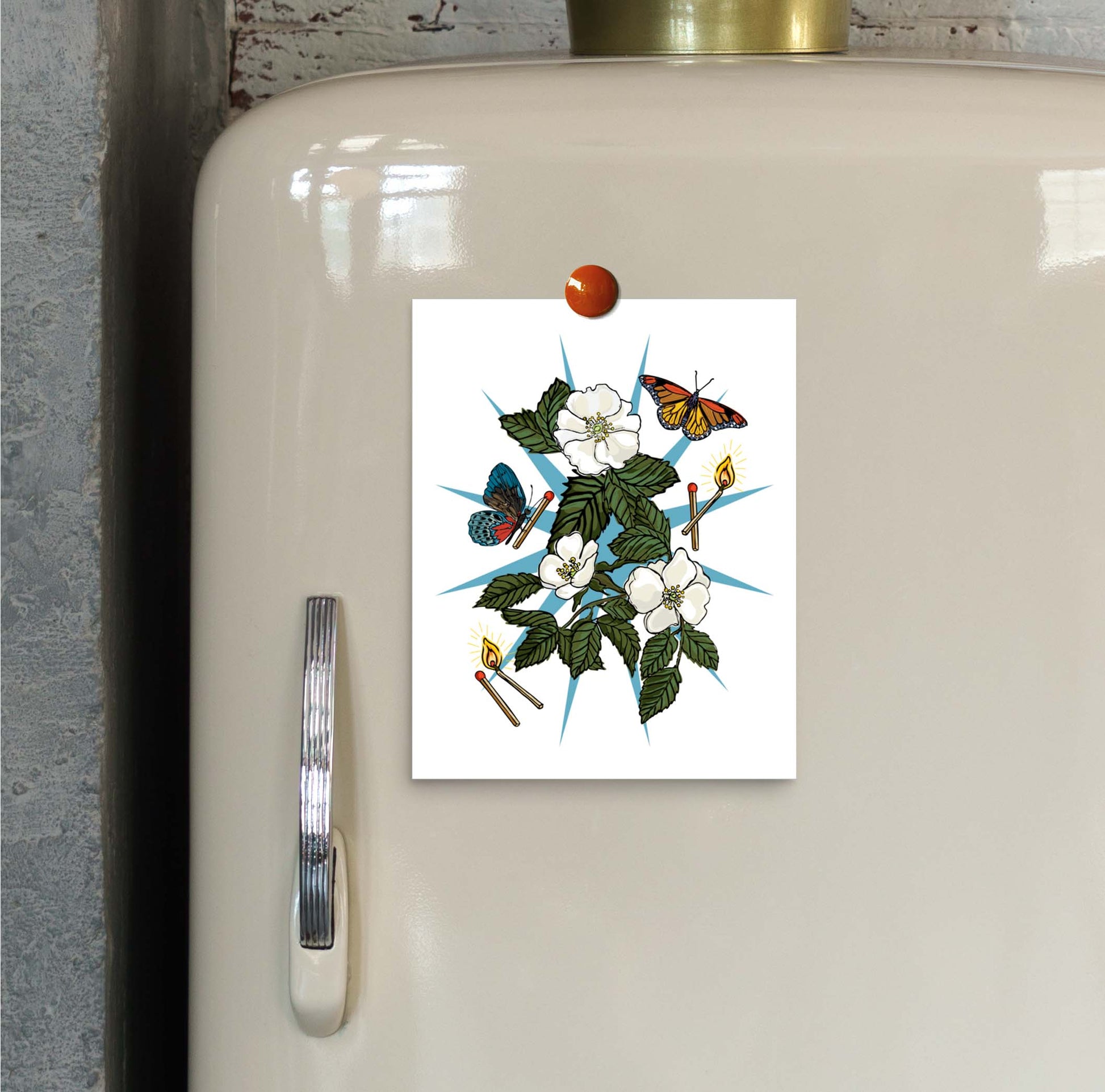 Wild Roses and Butterflies art print hung on an ivory vintage refrigerator door with a magnet.