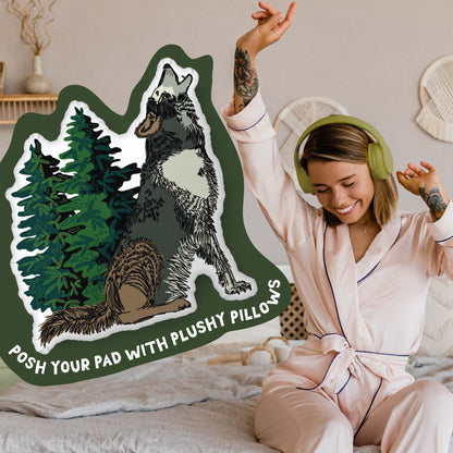 This image shows a photo of the rabbit-shaped pillow in a green organic shape. Inside the shape are the words "Posh your pad with plushy pillows". In the background, there is a photo of a woman in pajamas wearing headphones and sitting on a bed.